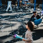 Children enjoy playing with bubbles at a playground